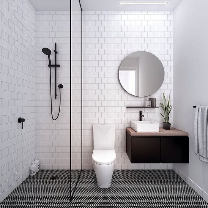 baño con suelo hidraulico gris y lavabo con mueble flotante