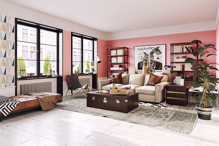 Gran salón con paredes con pintura sectorizada blanca y rosa y motivos geométricos