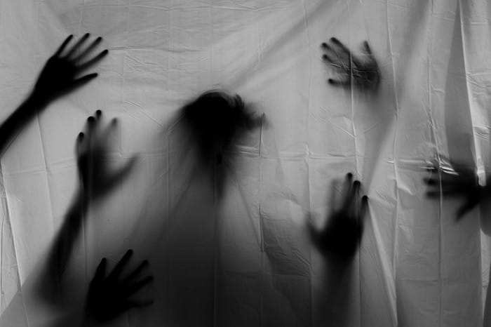 sombras de manos detrás de una sábana
