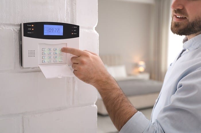 Hombre configurando el sistema de alarma aumentar la seguridad de tu casa