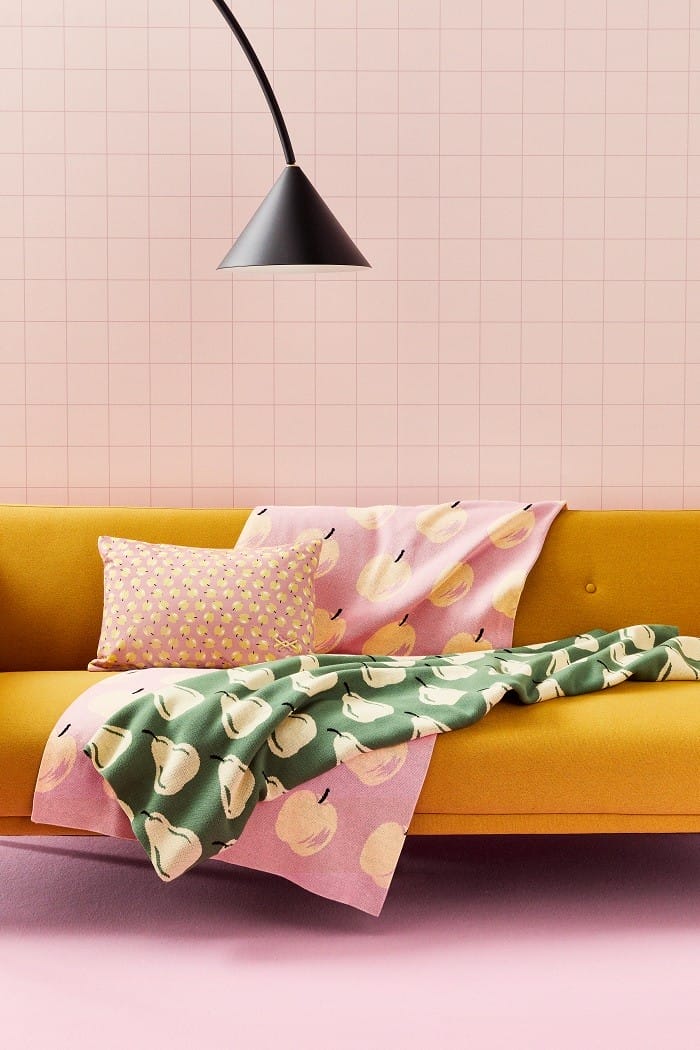 sofá con cojín estampado y toallas