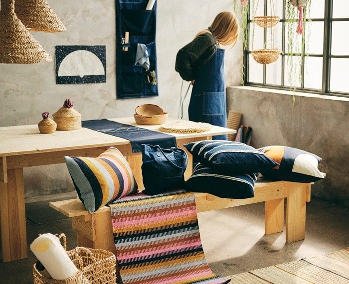 Espacio con artículos de la nueva colección de Ikea MAVINN y chica con delantal vaquero