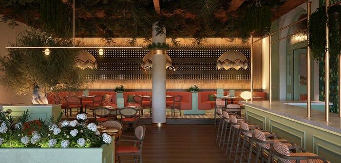 Interior de restaurante Isola en Marbella con sofás rojos y vegetación
