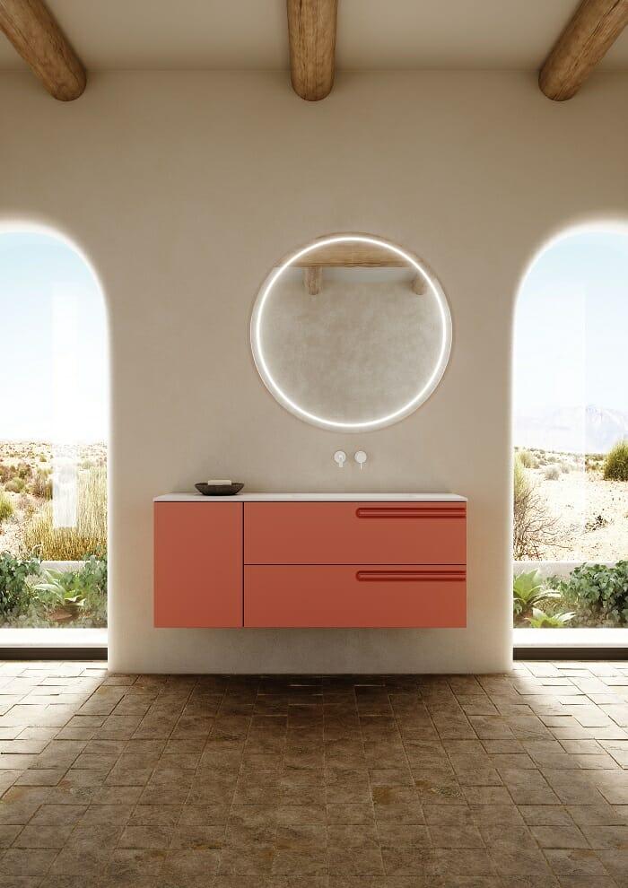 Lavabo de diseño en color coral con espejo con luz led