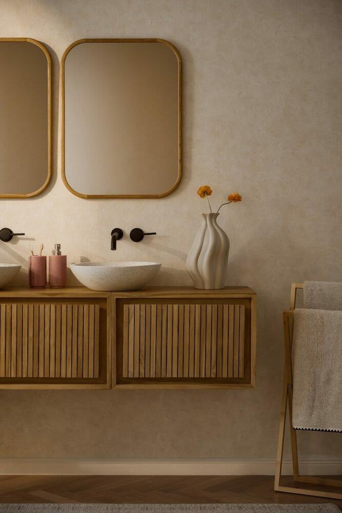 Lavabo blanco con un jarrón blanco y un mueble de madera