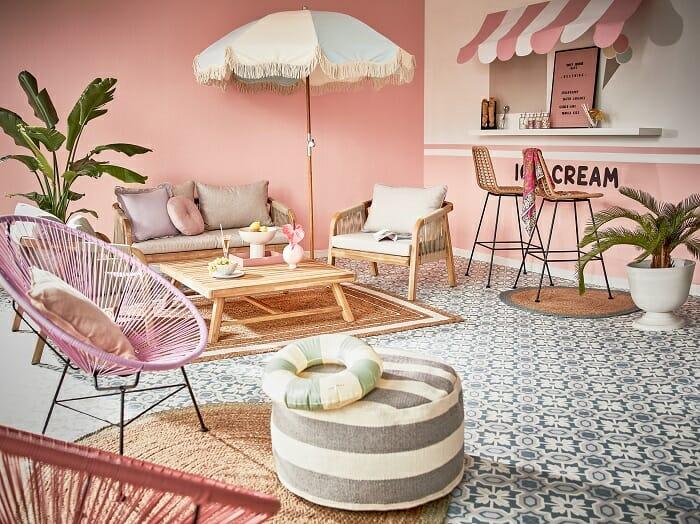 exterior con barra, sombrilla, sofá y sillas de estilo Barbiecore