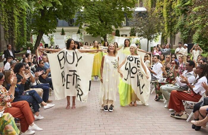 Pasarela de modelos con las organizadoras con pancartas defendiendo el medio ambiente y la sostenibilidad