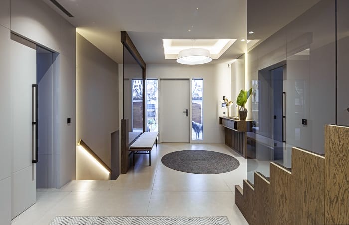 Hall entrada a una casa con iluminación en paredes y techos