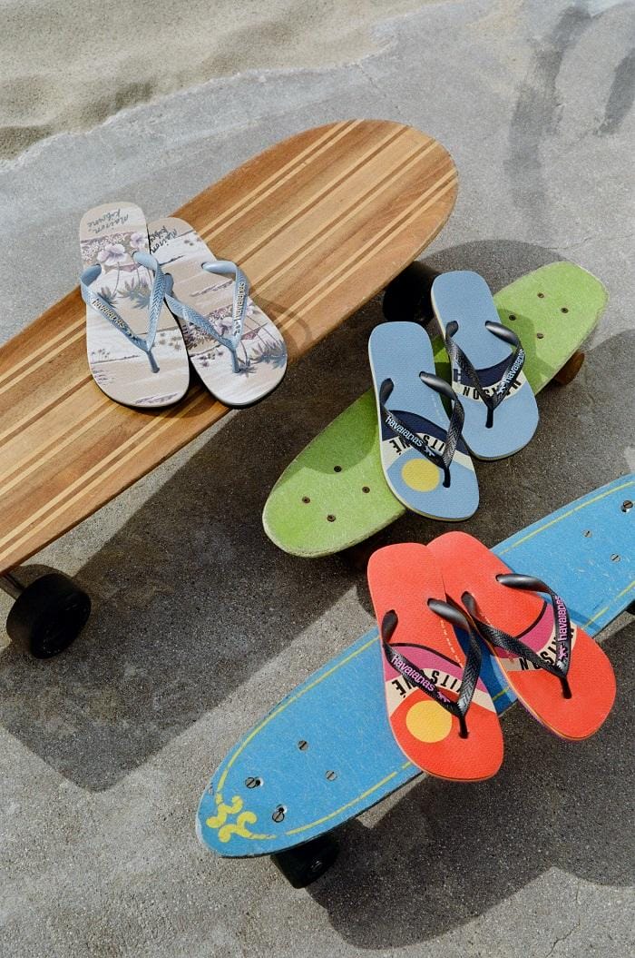 Varios tipos de chanclas en la arena havaianas