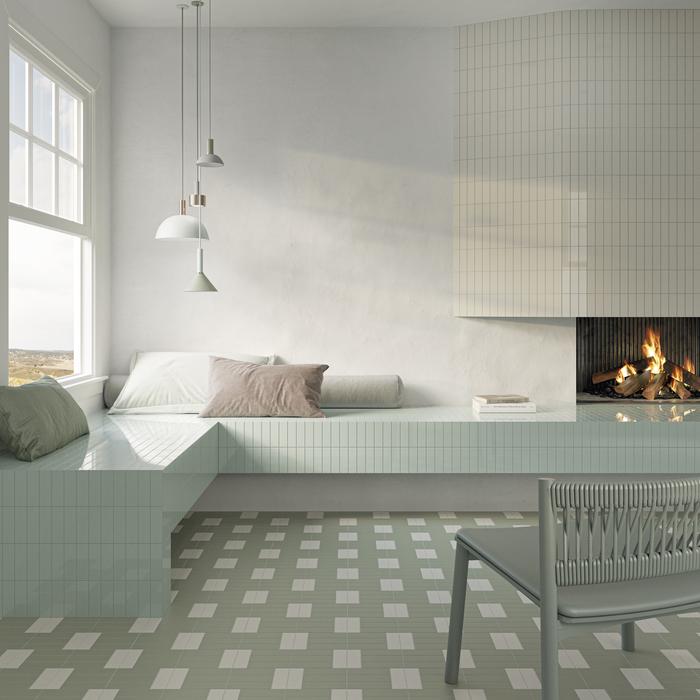 sala de descanso con suelo de diseño con círculos blanco y verde y sofá de cerámica verde