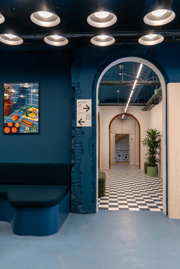 cuadro en pasillo con suelo cuadriculado y paredes azules