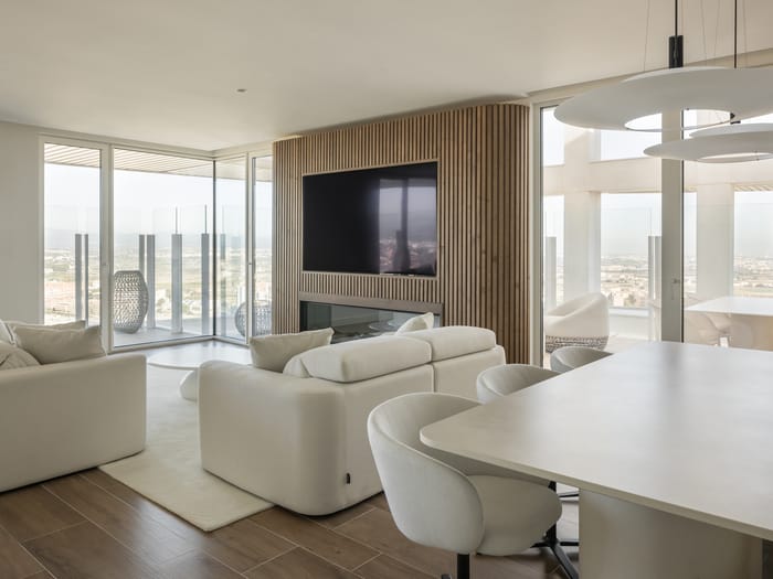 Sala de estar con diseño contemporáneo en la Torre IKON de Valencia, decorada con muebles minimalistas en tonos neutros diseño contemporáneo y calidez artesanal