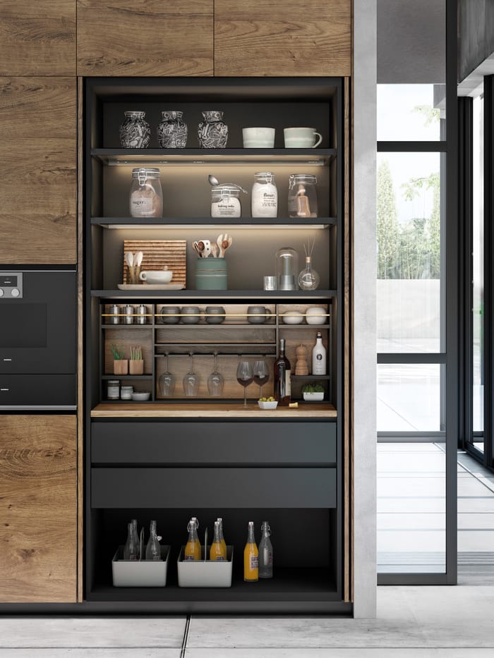 Mueble desayunador compacto y organizado, diseñado para guardar cafeteras, tostadoras y utensilios en un espacio limpio y funcional.